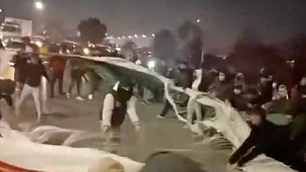 Sn�mek z videa, na n�m� lid� trhaj� �r�nskou vlajku. (8. ledna 2026)