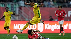 Olivier Verdon z Beninu p�eskakuje le�ícího Omara Marmoushe z Egypta.