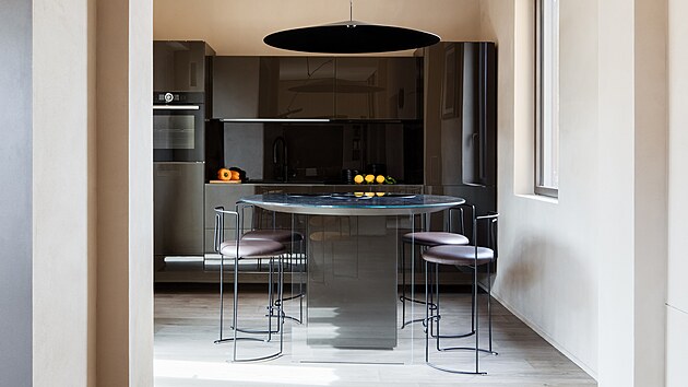 Nad kulatým stolem visí záv�sné svítidlo s výrazným socha�ským charakterem.