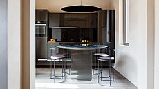 Nad kulatým stolem visí záv�sné svítidlo s výrazným socha�ským charakterem.