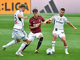 Spar�anský k�ídelník Veljko Birman�evi� se sna�í probít mezi dv�ma hrá�i...