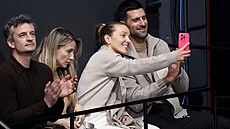 Tenista Novak Djokovi� s man�elkou sledují krasobruslení na olympijských hrách....