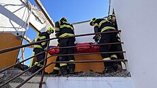 Záchraná�i a hasi�i pomáhali ve V�t�ní u mu�e, na kterého p�i demolici domu...