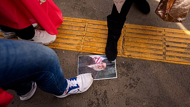 �lenov� �r�nsk� komunity �lapou na portr�t zesnul�ho �r�nsk�ho nejvy���ho v�dce ajatoll�ha Al�ho Chamene�ho na demonstraci p�ed �r�nskou ambas�dou v Bukure�ti v Rumunsku. (5. b�ezna 2026)