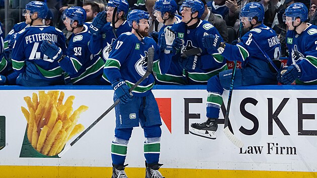 Obr�nce Vancouveru Filip Hronek slav� se spoluhr��i svou branku proti Carolin�.