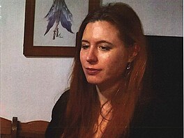 Poh�e�ovaná �ena by na sob� mohla mít dámský �erný kabát s bílým vzorem.