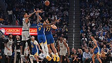 Victor Wembanyama ze San Antonio Spurs p�ihrává p�es bránící duo Nate Williams...