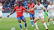 Plze�ský úto�ník Mohamed Toure s mí�em p�ed Simonem Bammensem z Pardubic