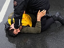 Turecký policista zadr�uje �lena odbor� b�hem pokusu o pochod na nám�stí Taksim...