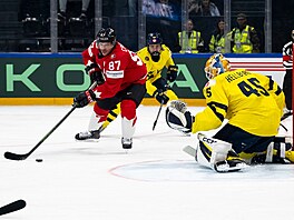 Sidney Crosby se sna�í zasunout puk za branká�e Magnuse Hellberga.