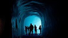 Turisté procházejí ledovou jeskyní v ledovci Mer de Glace u stanice Montenvers...