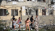 Obyvatelé opou�t�jí místo u obytného domu po�kozeného p�i ruském dronovém útoku...