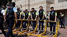 Policejní jednotky p�ed budovou soudu, kde byli t�i aktivisté odsouzeni za...