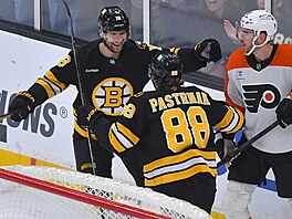 Bostonský úto�ník Pavel Zacha (�elem) slaví sv�j gól s Davidem Pastr�ákem,...