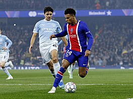 Abdukodir Khusanov z Manchesteru City proti Desire Douemu z PSG.