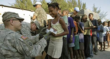 Americký voják rozdluje humanitární pomoc obtem zemtesení na Haiti.