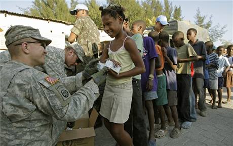Americký voják rozdluje humanitární pomoc obtem zemtesení na Haiti.