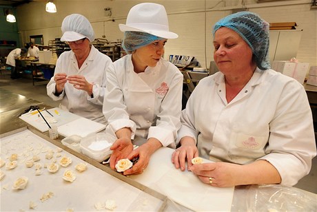 Vyhláená cukráka Fiona Cairnsová (uprosted) s kolegynmi Mary Doodyovou (vpravo) a Dianou Palletovou vyrábjí kvtinové dekorace pro královský svatební dort.