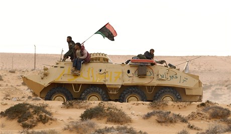 Libyjští rebelové na ukořistěném tanku nedaleko Rás Lanúfu. 
