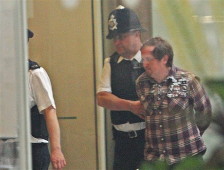 Policie odvádá Jonnieho Marblese poté, co zaútoil na Ruperta Murdocha (19. ervence 2011) 