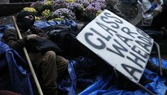 Spěje svět ke třídní válce? Mnozí účastníci protestů proti sociální nerovnosti jsou o tom přesvědčení. Na snímku jeden z nich spí vedle transparentu hlásajícího tuto hrozbu v Zuccotti Parku v New Yorku.