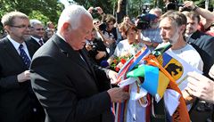 Prezident Václav Klaus navazuje stuhu na prapor �tafety cyklist� a b�c�, která na místo dorazila ze 730 kilometr� vzdáleného Ravensbrücku v N�mecku