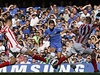 Fotbalista Chelsea Eden Hazard (uprosted) v obklíení hrá Stoke City Geoffa Camerona (vlevo) a Ryana Shawcrosse