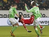 Padající fotbalista Bayernu Mario Manduki a Jan Polák (vlevo) a Alexander Madlung z Wolfsburgu