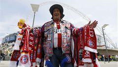 Fanoušek se před dějištěm finále Ligy mistrů - stadionem Wembley v Londýně - chlubí klubovými artefakty Bayernu Mnichov