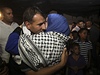 Proputný palestinský vze Husní Sawalha objímá svou rodinu