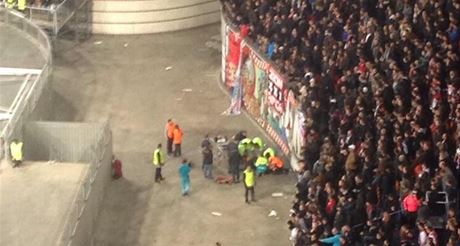 Poadatelé v Amsterdam Aren se sbíhají k fanoukovi, který spadl z tribuny