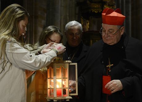 Kardinál Dominik Duka pebírá od skaut Betlémské svtlo.