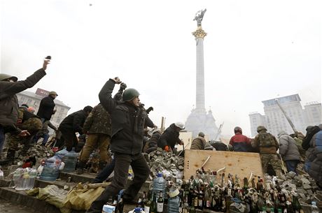 Demonstranti na Majdanu házejí dlaební kostky po policistech.