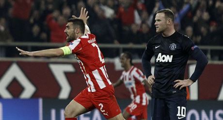 Giannis Maniatis slaví gól, Wayne Rooney z Manchesteru smutní