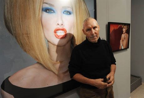 Michel Comte poses at the Leica Gallery in front of his photo of ex-fashion model Carla Bruni (now married to French President Nicolas Sarkozy), taken for Vogue Italia