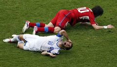 Greece's Giorgos Karagounis cries in pain after being kicked on the face by Czech Republic’s Tomáš Rosický during Tuesday’s match