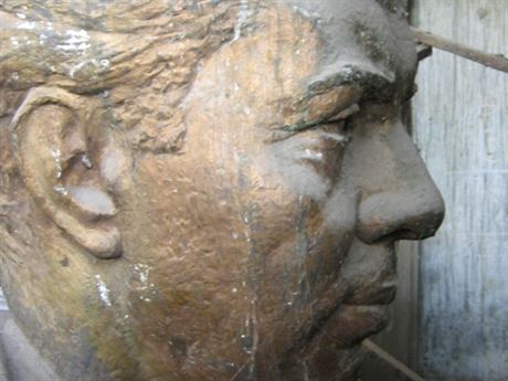 A discarded bust of Albanian dictator Enver Hoxha reflects on the "stimulant of oppression"