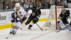 Útoník Chicago Blackhawks Jonathan Toews pesouvá puk za obránce Los Angeles...