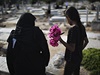 Palestinská ena pináí kvtiny k rodinnému hrobu v Gaze.