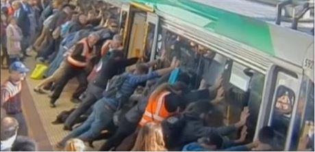 Cestující v australském Perthu naklání vlak, aby pomohli vyprostit dalího...