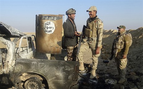 Irátí vojáci u znieného vozidla Islámského státu.