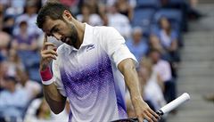 Marin Cilic, of Croatia, reacts after losing a point to Novak Djokovic, of...