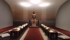 Dřevěná socha bódhisattvy, u které si mohou návštěvníci sednout a zamyslet se