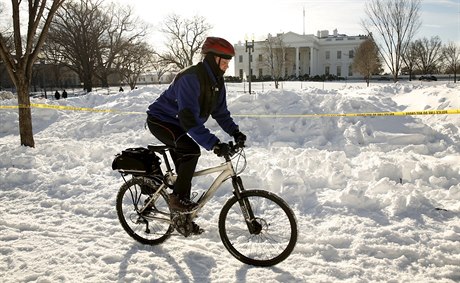 Cyklista projídí snnými závjemi. Na pozadí Bílý dm.