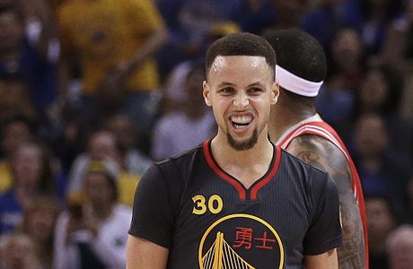 Golden State Warriors' Stephen Curry celebrates a score during the first half...
