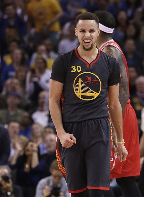 Golden State Warriors' Stephen Curry celebrates a score during the first half...