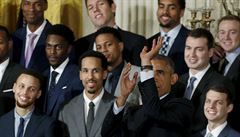 U.S. President Barack Obama simulates taking a shot as Golden State Warriors'...