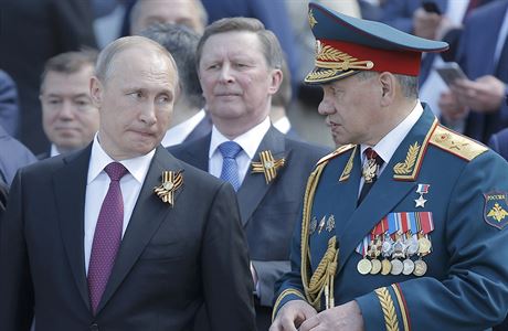 Vladimir Putin a ruský ministr obrany Sergej ojgu. Uprosted v pozadí éf...