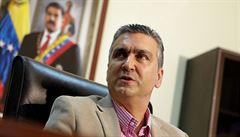 Venezuelský ministr ekonomiky Miguel Perez; v pozadí oficiální portrét...