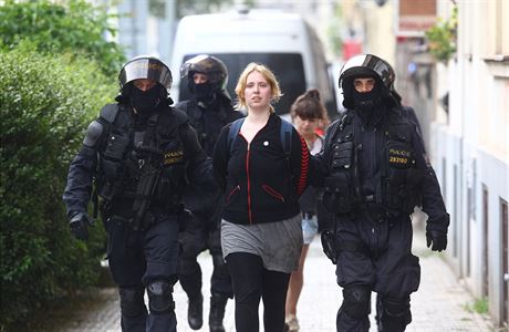 Policisté vyvádí jednu z aktivistek, která po nahláení bomby odmítla opustit...
